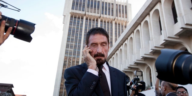 Dec. 4, 2012: Software company founder John McAfee talks on his mobile phone after a press conference outside the Supreme Court in Guatemala City.