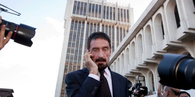 Dec. 4, 2012: Software company founder John McAfee talks on his mobile phone after a press conference outside the Supreme Court in Guatemala City.