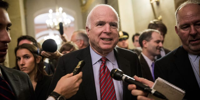 WASHINGTON, DC - OCTOBER 16: Sen. John McCain (R-AZ) answers questions as he arrives for a meeting of Senate Republicans on a solution for the pending budget and debt limit impasse at the U.S. Capitol October 16, 2013 in Washington, DC. The U.S. government shutdown is in its sixteenth day as the U.S. Senate and House of Representatives remain gridlocked on funding the federal government and the extending the nation's debt limit. (Photo by Andrew Burton/Getty Images)