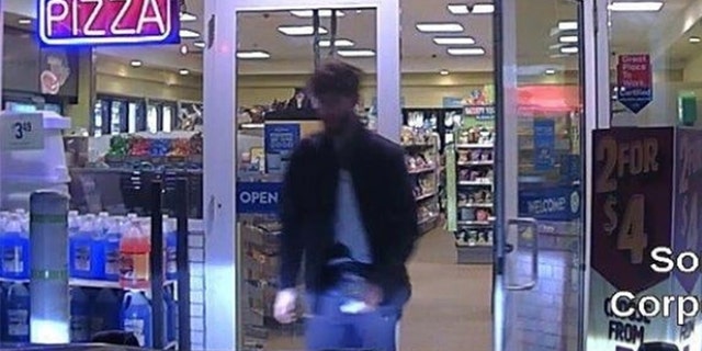 John Williams, 29, is seen leaving a convenience store early Wednesday, after police say he killed Corporal Eugene Cole.