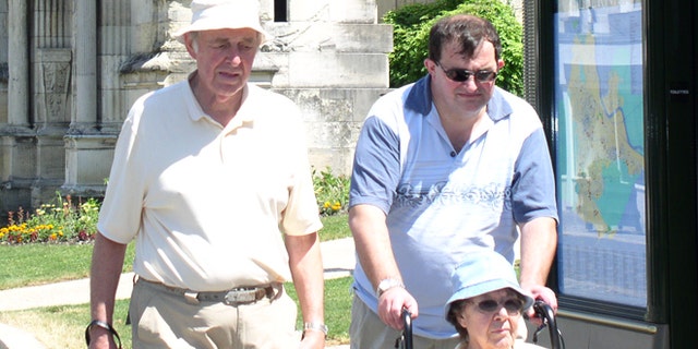 Robert Oliver is pictured here with his father, John, and mother, Betty, who died in 2012.