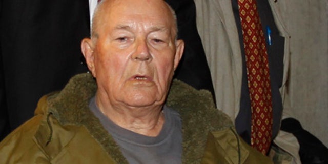 In this Thursday, May 12, 2011 file photo, John Demjanjuk leaves a courtroom in Munich. German police say sentenced Nazi criminal John Demjanjuk died Saturday March 17, 2012 at a home for the elderly in southern Germany where he has stayed since his trial ended in Munich last year.