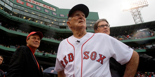 Sept. 28, 2008: Boston Red Sox great Johnny Pesky, center, is flanked by team president Larry Lucchino, left, and owner John Henry as they look past Pesky's Pole where Pesky's No. 6 adorns the upper deck during a ceremony to retire his number.