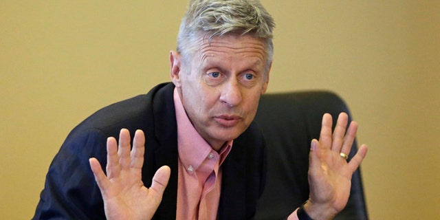 FILE - In this May 18, 2016 file photo, Libertarian presidential candidate, former New Mexico Gov. Gary Johnson speak with legislators at the Utah State Capitol in Salt Lake City. Utah Republicans, mostly Mormons, are now struggling to figure out how to cast their vote this November. Donald Trump has shattered the normal Republican consensus in Utah even more so than he has nationwide, activating fault lines under a normally stable electorate largely unified by a single religion. (AP Photo/Rick Bowmer, File)