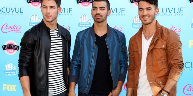 Nick, Joe and Kevin Jonas pose as they arrive at the Teen Choice Awards at the Gibson amphitheatre in Universal City, California August 11, 2013.
