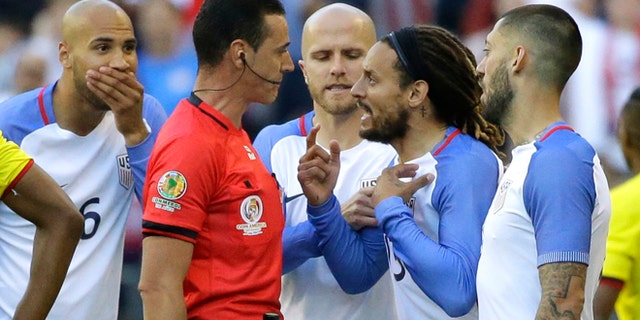 United States midfielder Jermaine Jones, second from right, protests to referee Wilmar Roldan, second from left, after Roldan gave Jones a red card in the second half of a Copa America Centenario soccer match against Ecuador, Thursday, June 16, 2016 at CenturyLink Field in Seattle. The United States beat Ecuador 2-1. (AP Photo/Ted S. Warren)