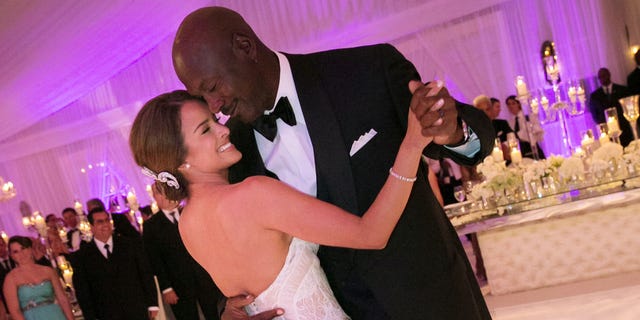In this Saturday, April 27, 2013, photo provided by JUMP.DC, Charlotte Bobcats owner Michael Jordan dances with his bride Yvette Prieto during their wedding reception at the Bear's Club in Jupiter, Fla. The wedding took place at the Episcopal Church of Bethesda-by-the-Sea with more than 300 guests in attendance, including Tiger Woods, Patrick Ewing and Ahmad Rashad, Jordan's manager Estee Portnoy told The Associated Press Sunday.