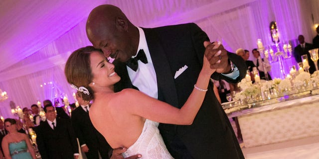 In this Saturday, April 27, 2013, photo provided by JUMP.DC, Charlotte Bobcats owner Michael Jordan dances with his bride Yvette Prieto during their wedding reception at the Bear's Club in Jupiter, Fla. The wedding took place at the Episcopal Church of Bethesda-by-the-Sea with more than 300 guests in attendance, including Tiger Woods, Patrick Ewing and Ahmad Rashad, Jordan's manager Estee Portnoy told The Associated Press Sunday.