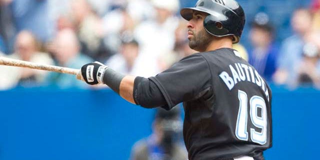 Toronto Blue Jays' Jose Bautista watches his three-run home run hit during the first inning of a baseball game, Saturday, May 28, 2011, in Toronto. (AP Photo/The Canadian Press, Darren Calabrese)