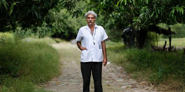 FILE - In this Nov. 6, 2013 file photo, Doctor Jose Manuel Mireles, leader of his town's self-defense group, poses for a portrait on his property in Tepalcatepec, in the state of Michoacan, Mexico. On Saturday Jan. 4, 2014, Mireles was badly injured when a single engine aircraft in which he was traveling crashed near the town of La Huacana. Mireles has been coordinating the efforts of several self-defense groups who are trying to get the Knight Templars drug cartel out of the state of Michoacan. (AP Photo/Dario Lopez-Mills, File)