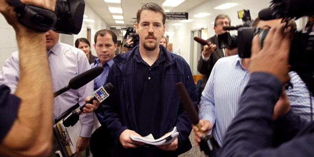 FILE - In this Sept. 23, 2011, file photo, Josh Powell, the husband of missing Utah woman Susan Powell, is surrounded by reporters as he leaves a Pierce County courtroom in Tacoma, Wash. FBI documents say investigators found child pornography on Powell's computer at least 17 months before he killed his children and himself. (AP Photo/Ted S. Warren, File)