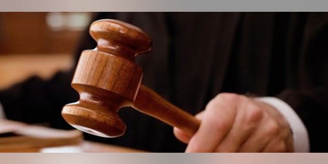 Judge holding gavel in a courtroom (Getty Images)