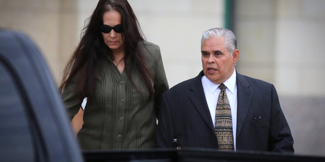 Aug 21, 2013: Former 404th state District Judge Abel Limas, right, quickly exits the federal courthouse in Brownsville, Texas.