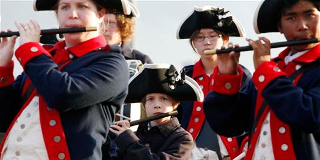 On July 1, members of the William Diamond Junior Fife and Drum Corp from Lexington, Massachusetts, perform on the site of the USS Constitution as part of recent Independence Day weekend events in Boston.