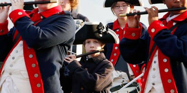 On July 1, members of the William Diamond Junior Fife and Drum Corp from Lexington, Massachusetts, perform on the site of the USS Constitution as part of recent Independence Day weekend events in Boston.