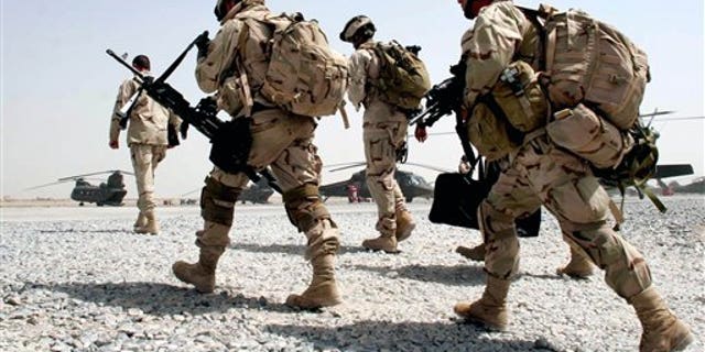 U.S. soldiers walk to board a helicopter in the airbase in Kandahar, southern Afghanistan, on June 25, 2005.