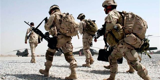 U.S. soldiers walk to board a helicopter in the airbase in Kandahar, southern Afghanistan, on June 25, 2005.