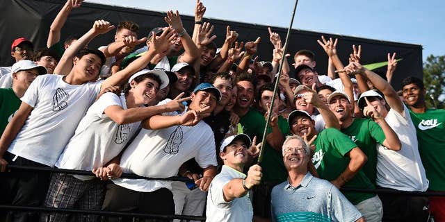 Rory McIlroy uses a selfie stick to take a photo with many of the 54 golfers at the Junior Invitational golf tournament, after speaking to them following the second round at Sage Valley Golf Club in Graniteville, S.C., on Friday, April 24, 2015. (Jon-Michael-Sullivan/The Augusta Chronicle via AP)