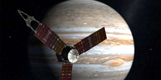 The Juno spacecraft passes in front of Jupiter in this artist's depiction.