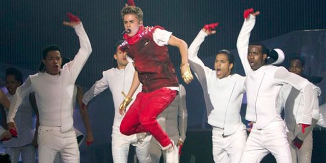 FILE - This June 17, 2012 file photo shows singer Justin Bieber performing during the 2012 Much Music Video Awards in Toronto. Bieber’s “Believe” is the year’s top-selling debut. Nielsen SoundScan reports sales of 374,000 copies following its release last week, giving the 18-year-old Canadian pop singer the fourth No. 1 album and the best sales week of his young career. “Believe” also debuted at No. 1 in 29 other countries. (AP Photo/The Canadian Press, Chris Young, file)