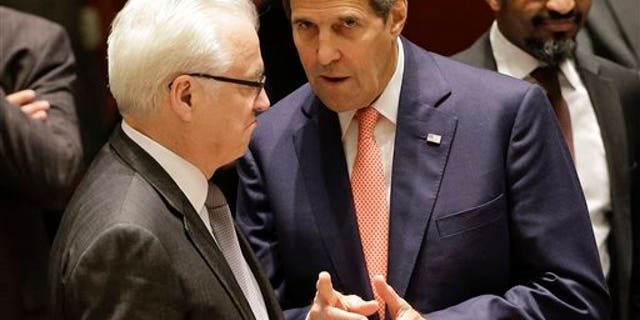 U.S. Secretary of State John Kerry, right, talks with Vitaly Churkin, Russian permanent resident to the United Nations, before a meeting of the U.N. Security Council, Friday, Sept. 19, 2014, at United Nations headquarters. The security council met Friday to discuss the situation in Iraq. (AP Photo/Julie Jacobson)
