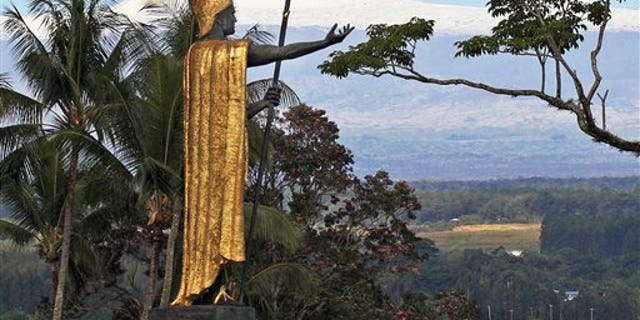 This Jan. 31, 2014, file photo, shows a statue of Hawaiian King Kamehameha I with snow-capped Mauna Kea in the distance, in Hilo, Hawaii. Part of Kamehameha's spear is missing.