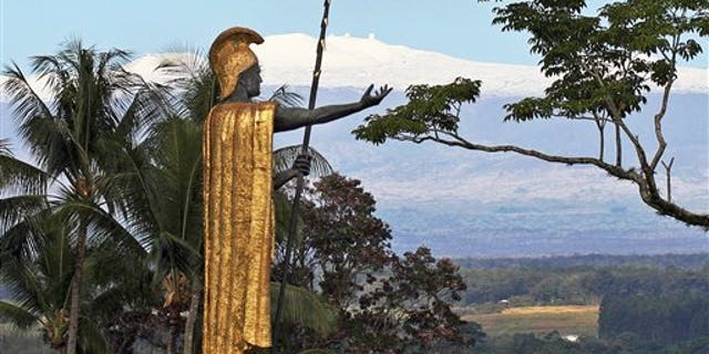 This Jan. 31, 2014, file photo, shows a statue of Hawaiian King Kamehameha I with snow-capped Mauna Kea in the distance, in Hilo, Hawaii. Part of Kamehameha's spear is missing.