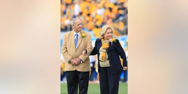 Former West Virginia head coach Bobby Bowden, left, with his wife Ann attend a ceremony where he was awarded the WVU Outstanding Alumni Award during halftime of an NCAA college football game in Morgantown, W.Va., Saturday, Oct. 4, 2014. (AP Photo/Chris Jackson)
