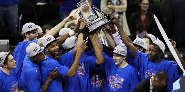 The Kansas Jayhawks celebrate winning the final of the Big 12 men's basketball tournament against Texas in Kansas City, Mo., Saturday, March 12, 2011. (AP Photo/Orlin Wagner)