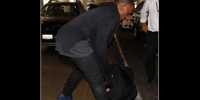 July 19, 2013: Kanye West Attacks Photographer At LAX