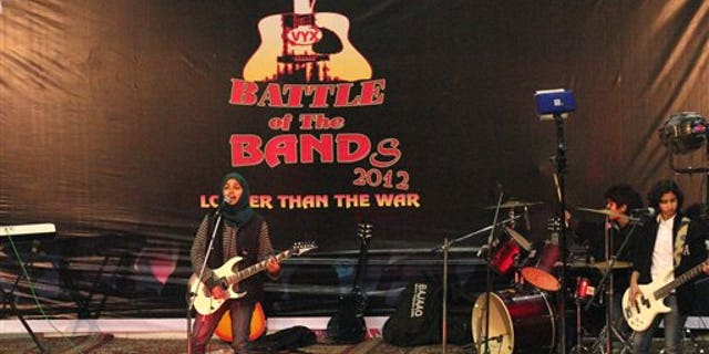 In this Sunday, Dec. 23, 2012 photo, members of Indian-controlled Kashmirs first all-girl rock band Pragaash, or First Light, perform at the annual Battle of the Bands in Srinagar, India.