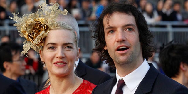 Dec. 9, 2012: In this file photo, British actress Kate Winslet, left, arrives with Ned Rocknroll at the awards presentation of The Longines Hong Kong Cup horse race at the Shatin race track in Hong Kong.