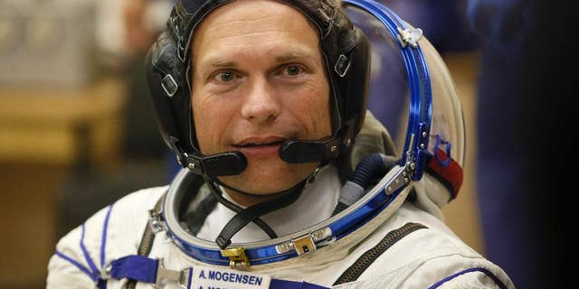 Denmark's astronaut Andreas Mogensen, member of the main crew of the expedition to the International Space Station (ISS), speaks with his family through a safety glass prior the launch of Soyuz-FG rocket at the Russian leased Baikonur cosmodrome, Kazakhstan, Wednesday, Sept. 2, 2015. (AP Photo/Dmitry Lovetsky)