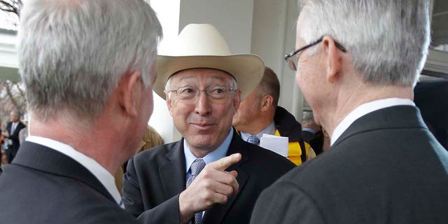 U.S. Interior Secretary Kenneth Salazar gestures after a news conference in Boston, Tuesday, April 19, 2011. A federal agency approved a construction and operations plan for the Cape Wind project off the Massachusetts coast, clearing the way for work to begin on America's first offshore wind farm as early as this fall, which was announced by Salazar. At left is Massachusetts Secretary of Energy and Environmental Affairs Richard Sullivan, and at right is Cape Wind Associates Vice President Dennis Duffy. (AP Photo/Charles Krupa)