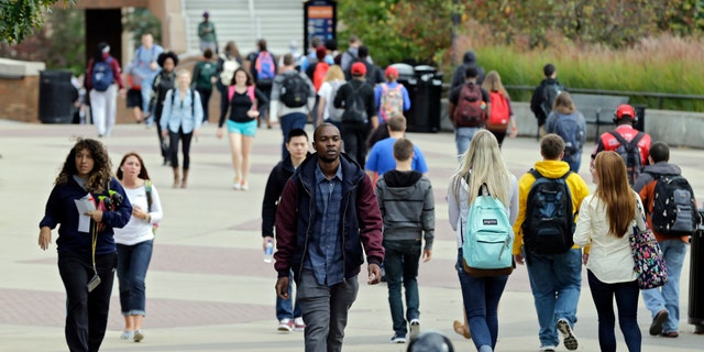 Oct. 15, 2014: Students walk the campus at Kent State University in Kent, Ohio. Students and staff were notified that three employees of the university are related to the nurse in Dallas who exhibited Ebola symptoms and had contact with her over the weekend.