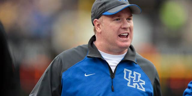 FILE - In this Nov. 16, 2013 file photo, Kentucky head coach Mark Stoops watches from the sideline in the second quarter of an NCAA college football game against Vanderbilt in Nashville, Tenn. Stoops begins fall practice on Monday, Aug. 4, 2014, seeking progress in his second season. He's encouraged by the Wildcats' attitude and improved grasp of the system and believes that can end a string of consecutive 2-10 finishes.(AP Photo/Mark Humphrey, File)