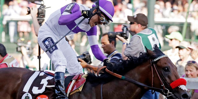 Mario Gutierrez celebrates after riding Nyquist to victory during the 142nd running of the Kentucky Derby horse race at Churchill Downs Saturday, May 7, 2016, in Louisville, Ky. (AP Photo/Garry Jones)