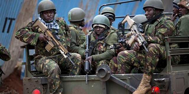 Trucks of soldiers from the Kenya Defense Forces arrive after dawn outside the Westgate Mall in Nairobi, Kenya Sunday, Sept. 22, 2013. Islamic extremist gunmen lobbed grenades and fired assault rifles inside Nairobi's top mall Saturday, killing dozens and wounding over a hundred in the attack. Early Sunday morning, 12 hours after the attack began, gunmen remained holed up inside the mall with an unknown number of hostages. (AP Photo/Ben Curtis)