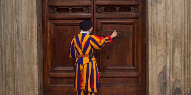 Jan. 14, 2014 - FILE photo: A member of the Swiss Guard unlocks the door to the Sistine Chapel for Secretary of State John Kerry during a tour of the Vatican.