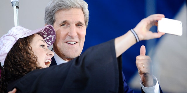 Secretary of State John Kerry, right poses for a selfie with Yale student Ariel Kirshenbaum during Class Day at Yale University, Sunday, May 18, 2014, in New Haven, Conn. (AP Photo/Jessica Hill)
