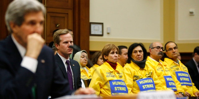 FILE: Dec. 10, 2013: Families of Iranian dissidents and Secretary of State John Kerry on Capitol Hill about Iran's nuclear programs, Washington, D.C.