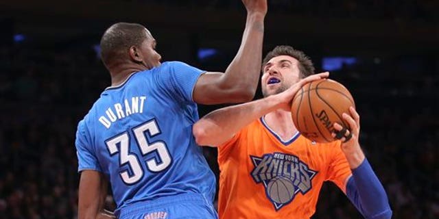 Knicks' Andrea Bargnani shoots against Oklahoma City Thunder's Kevin Durant at Madison Square Garden, Wednesday, Dec. 25, 2013, in New York.