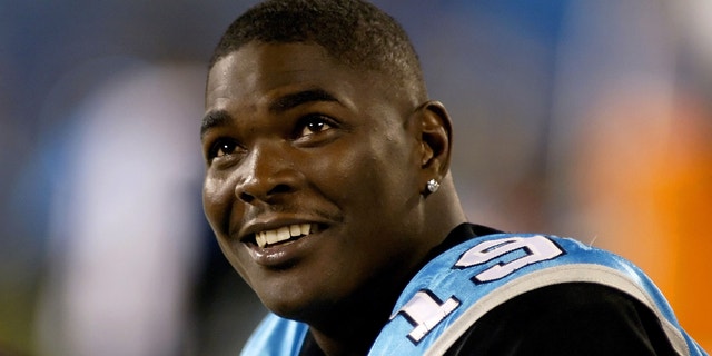 Wide receiver Keyshawn Johnson of the Carolina Panthers smiles from the sidelines against the Miami Dolphins during the second half of a preseason football game at Bank of America Stadium in Charlotte, North Carolina August 24, 2006.