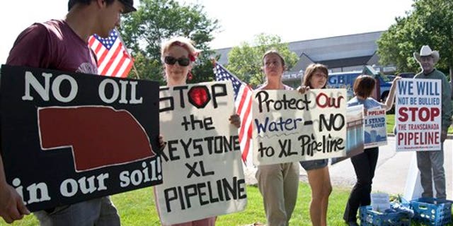 July 26: Protestors opposed to the Keystone XL pipeline hold signs outside the office of Rep. Lee Terry, R-Neb., in Omaha, Neb.