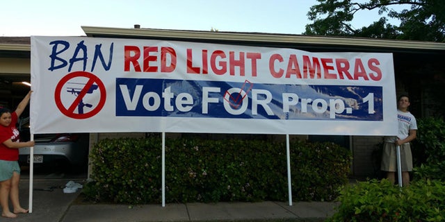 Anti-traffic camera protesters are seen demonstrating in Arlington.