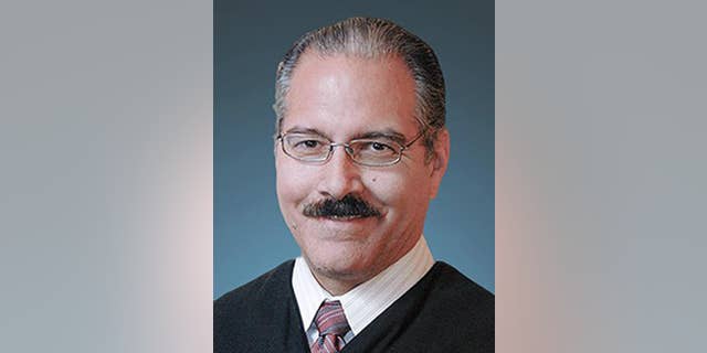 This photo provided by the Tulsa County District Court shows District Judge James Caputo. Caputo, who is assigned to the case of a volunteer deputy accused of manslaughter in the shooting of a restrained suspect, said in a court filing Wednesday, April 22, 2015 that he is considering whether to recuse himself due to his close ties to the Tulsa, Oklahoma, sheriff's office. (Tulsa County District Court via AP)