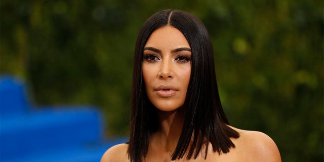 Kim Kardashian was seen enjoying some R&amp;R as she posed in a tiny black string bikini in several throwback posts. 