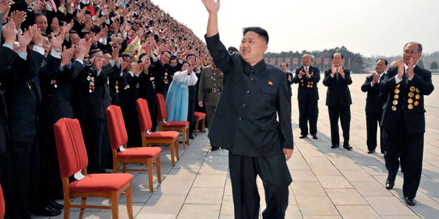 April 19: North Korean leader Kim Jung-Un waves as he arrives to take pictures with officials, creators and employees of the Mansudae Art Studio in Pyongyang.