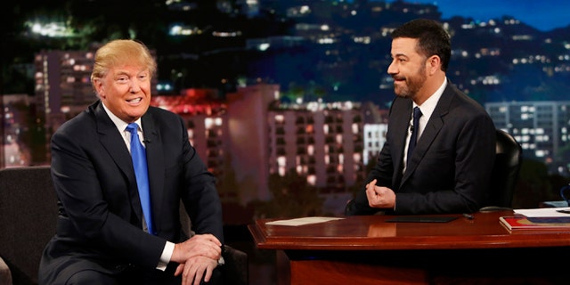 This photo provided by ABC shows guest Republican Presidential candidate Donald Trump, left, with host Jimmy Kimmel, on Jimmy Kimmel Live on Wednesday, Dec. 16, 2015, in Los Angeles. The ABC show airs every weeknight, 11:35 p.m. - 12:41 a.m., ET. (Randy Holmes/ABC via AP)
