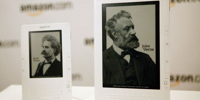 Two models of the Amazon Kindle stand side by side on display.